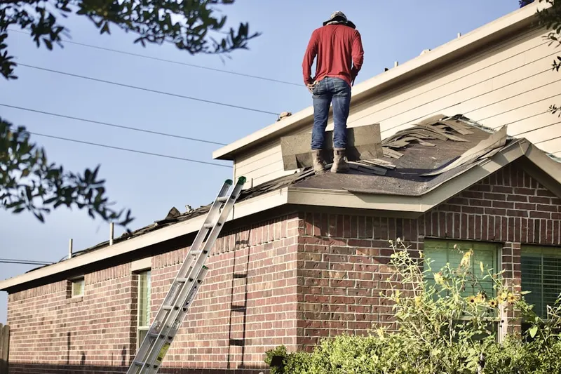 Professional roofer working on a residential roof in Rockland Hills